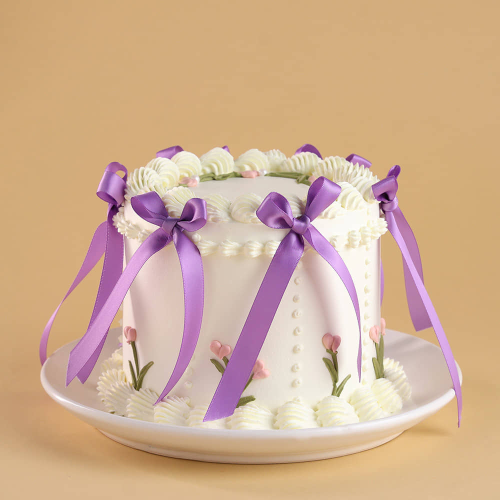 Front Angled View of Floral Swirls Ribbon Cake